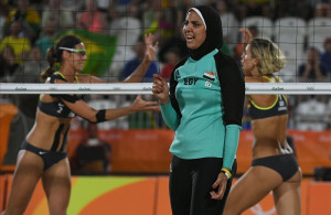 Egypt s Doaa Elghobashy C reacts as Germany s Kira Walkenhorst L and Germany s Laura Ludwig celebrate winning a point during the women s beach volleyball qualifying match between Germany and Egypt at the Beach Volley Arena in Rio de Janeiro on August 7 2016 for the Rio 2016 Olympic Games AFP PHOTO Yasuyoshi Chiba